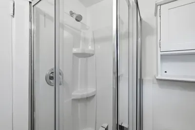 Nice sleek glass shower and handy built-in storage
