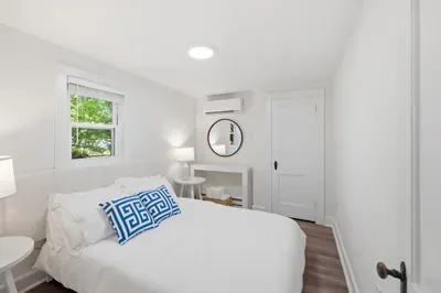 Cozy bedroom with natural light, AC, and fresh modern style