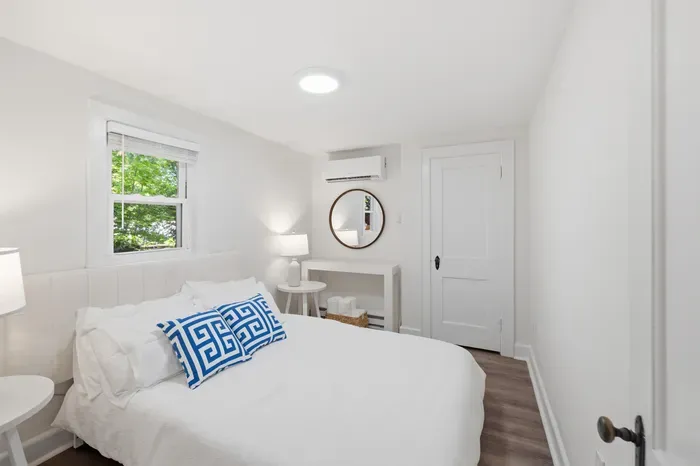 Cozy bedroom with natural light, AC, and fresh modern style