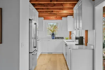 Bright modern kitchen with exposed wood beams and sleek finishes