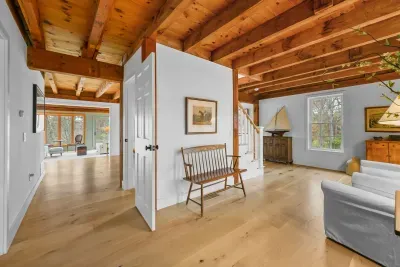 Bright open living space with exposed beams and warm wood finishes