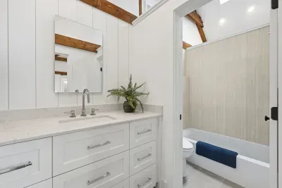 Bright modern bathroom with stylish vanity and tub-shower combo