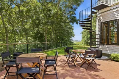 Private tree-lined patio with outdoor seating and peaceful nature views