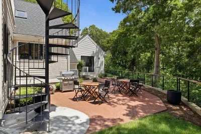 Private wooded patio with grill, café seating, and charming spiral stairs