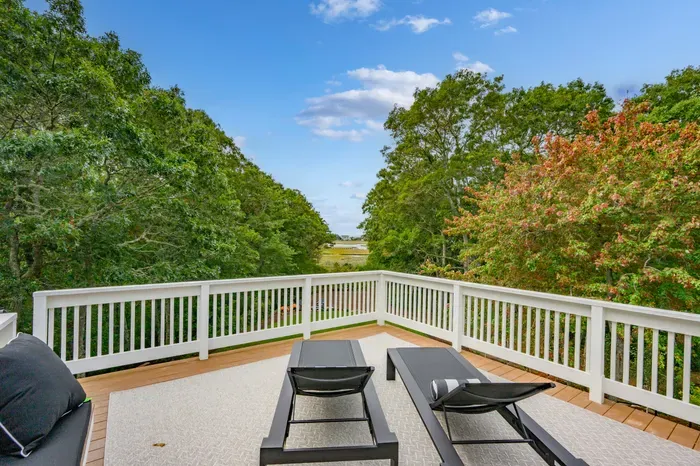 Private treetop deck with lounge seating and peaceful water views