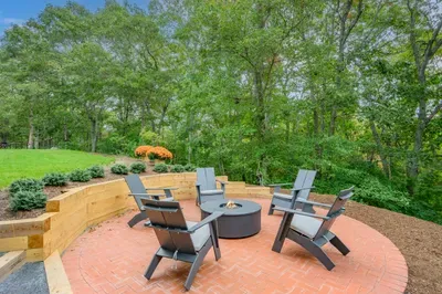 Private wooded patio with fire pit and stylish outdoor seating