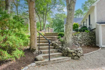 Tree-lined stone steps create a peaceful, welcoming approach