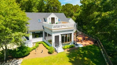 Private tree-lined retreat with sunny deck, patio dining, and lush lawn