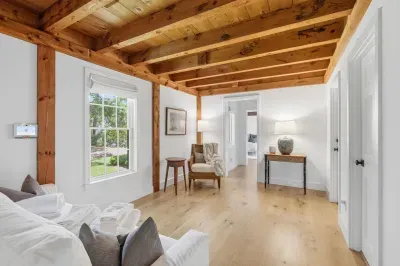 Bright rustic retreat with exposed beams and airy natural light