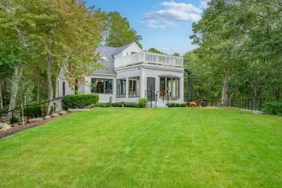 Spacious lawn, wooded privacy, and a lovely deck for outdoor relaxation