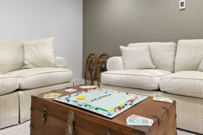 Cozy game lounge with plush sofas and rustic cabin charm