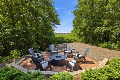Private wooded fire pit patio with scenic views and cozy seating