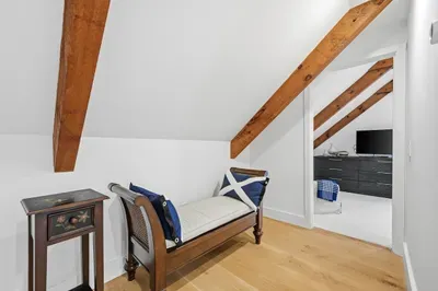 Charming loft landing with exposed beams and cozy seating nook