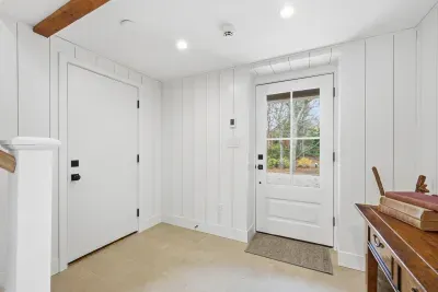 Bright modern farmhouse entryway with natural light and stylish wood accents