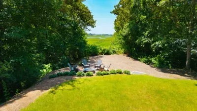 Private backyard retreat with fire pit and peaceful water views