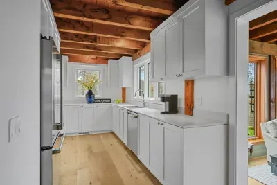Bright modern kitchen with rustic wood beams and sunlit charm