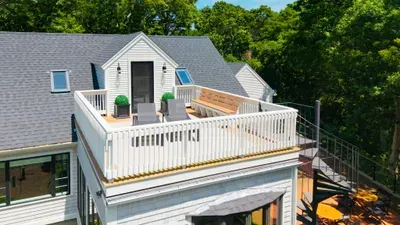 Spacious rooftop deck with treetop views and stylish lounge seating