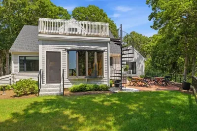 Private yard, patio dining, and a rooftop deck surrounded by trees