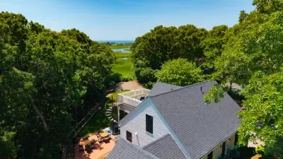Private tree-lined retreat with deck, patio, and serene marsh views