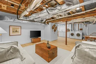 Spacious lower-level lounge with TV and in-home laundry