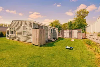 An outdoor shower is available, perfect for rinsing off after a day at the beach. And cornhole lawn games