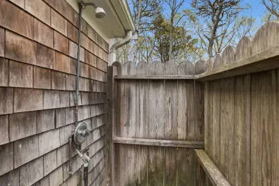 Private outdoor shower with fenced privacy and coastal charm