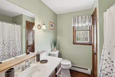 Bright, airy bathroom with natural light and warm wood accents