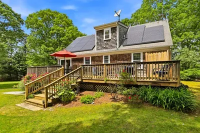 Charming shingle home with sunny deck, garden views, and peaceful yard