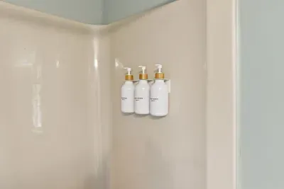 Clean shower with mounted premium toiletries for a hotel-style stay