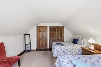 Cozy loft-style bedroom with two beds and warm, inviting touches