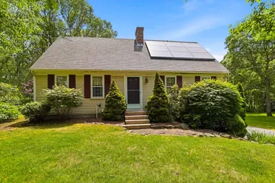 Charming cottage with lush yard, wooded privacy, and eco-friendly solar