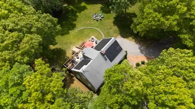 Private wooded retreat with deck, fire pit, and spacious backyard