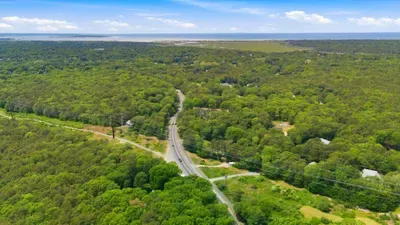 Peaceful wooded setting with scenic road access and distant coastal views
