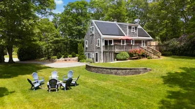 Spacious private yard with deck, fire pit, and peaceful wooded setting