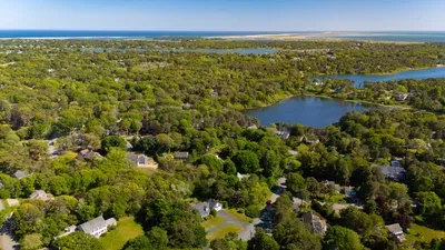 Scenic aerial view near ponds, lush greenery, and the coastline