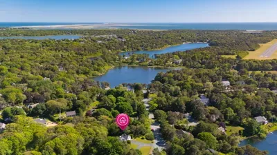 Scenic coastal setting with ponds, lush greenery, and ocean nearby
