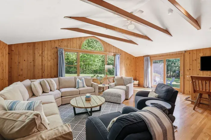Bright vaulted living room with exposed beams and garden views