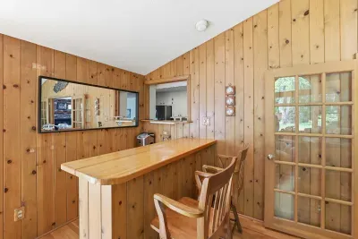 Cozy wood-paneled breakfast bar with cabin charm and seating for two