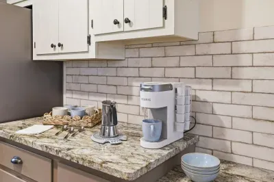 Granite-top coffee bar with Keurig, mugs & K‑cups—ready for your mornings