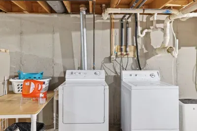 In-home washer & dryer with supplies and folding table—guest-ready.