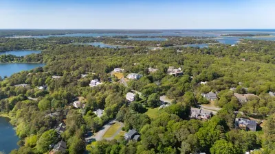 Aerial view of a lush coastal neighborhood with water all around