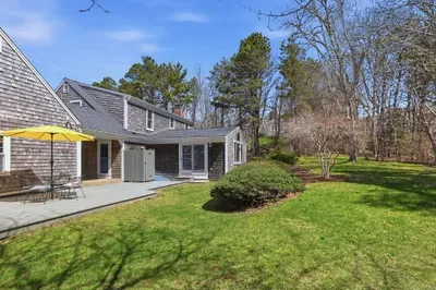 Shingle home with sunny deck, outdoor shower & spacious lawn