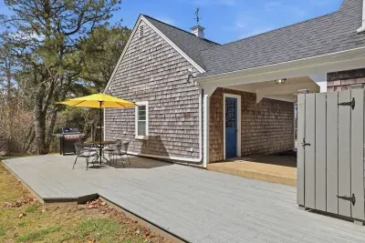 Sunny deck with BBQ, dining set & outdoor shower—coastal retreat
