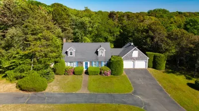 Charming wooded retreat with spacious yard and classic curb appeal
