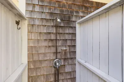 Private outdoor shower with coastal charm and fenced-in privacy