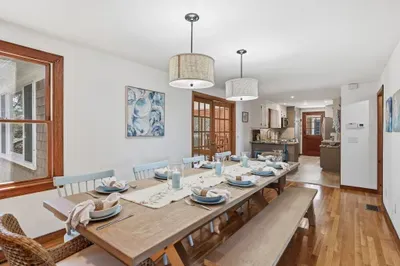 Spacious farmhouse dining for 10+, open to kitchen and light-filled