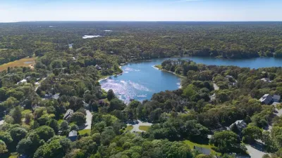 Scenic lakefront setting surrounded by lush trees and peaceful privacy
