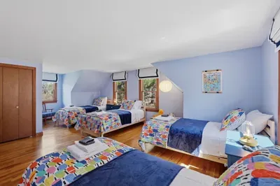 Sunny room with 4 twin beds—bright, playful, and perfect for families
