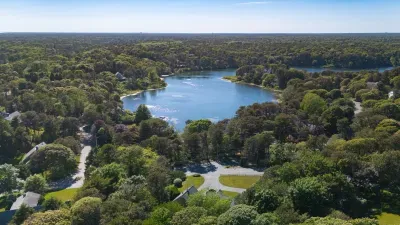Peaceful lakefront setting surrounded by lush trees and scenic views