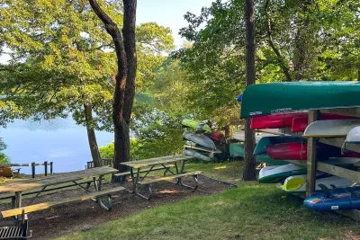 Lakeside retreat with kayaks, dock access, and shaded picnic spots